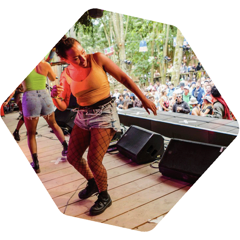 Photo of a women dancing on a stage in front of a crowd