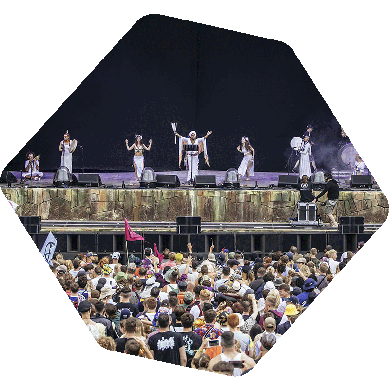 Photo of a crowd in front of a stage with performers on it