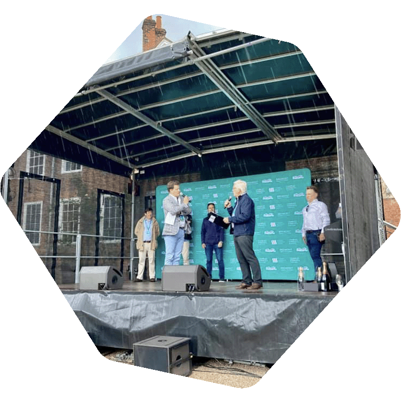 Photo of presenters on a mobile trailer stage