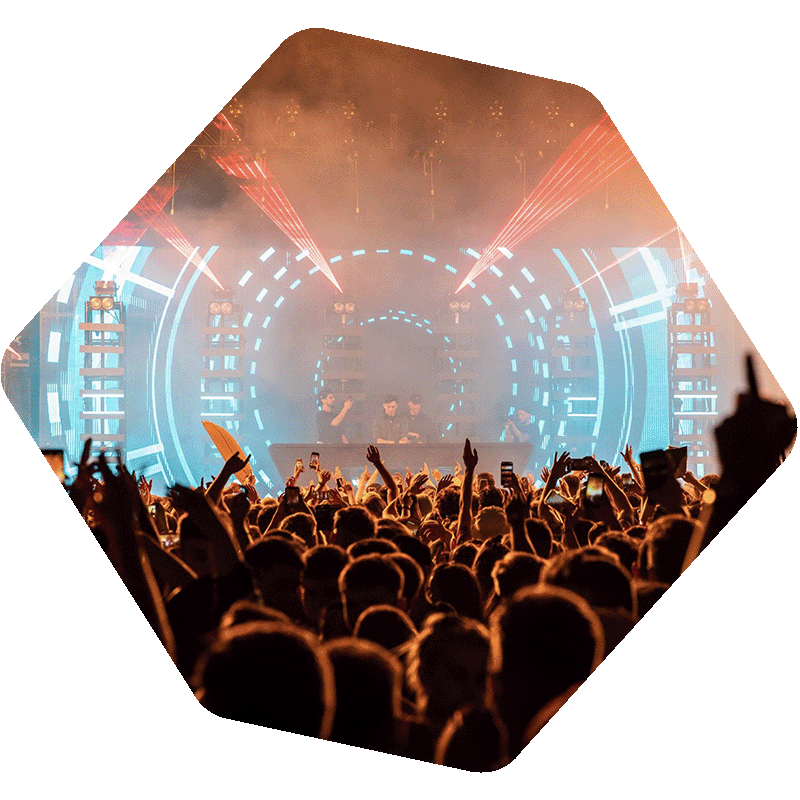 Photo of a crowd in front of a stage with lights