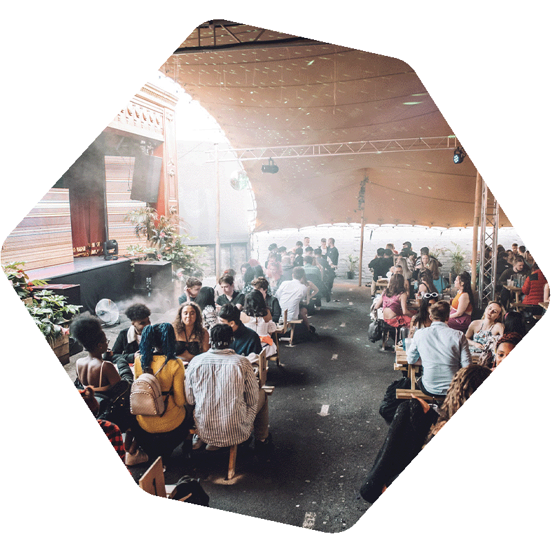 People on benches at an outdoor venue