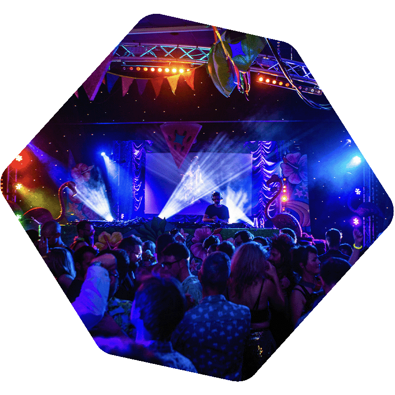 Crowd of people in front of a DJ set with lights