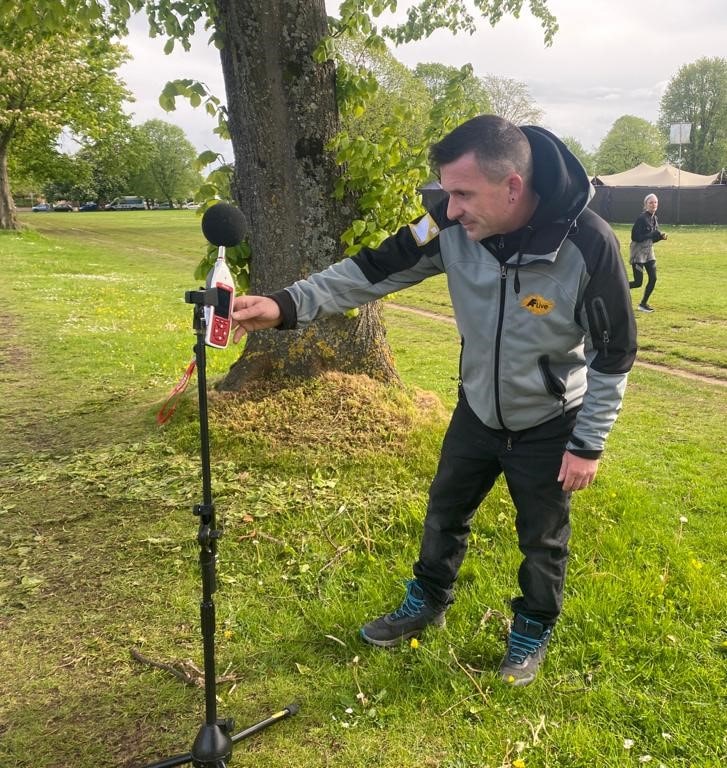 Man measuring sound outside